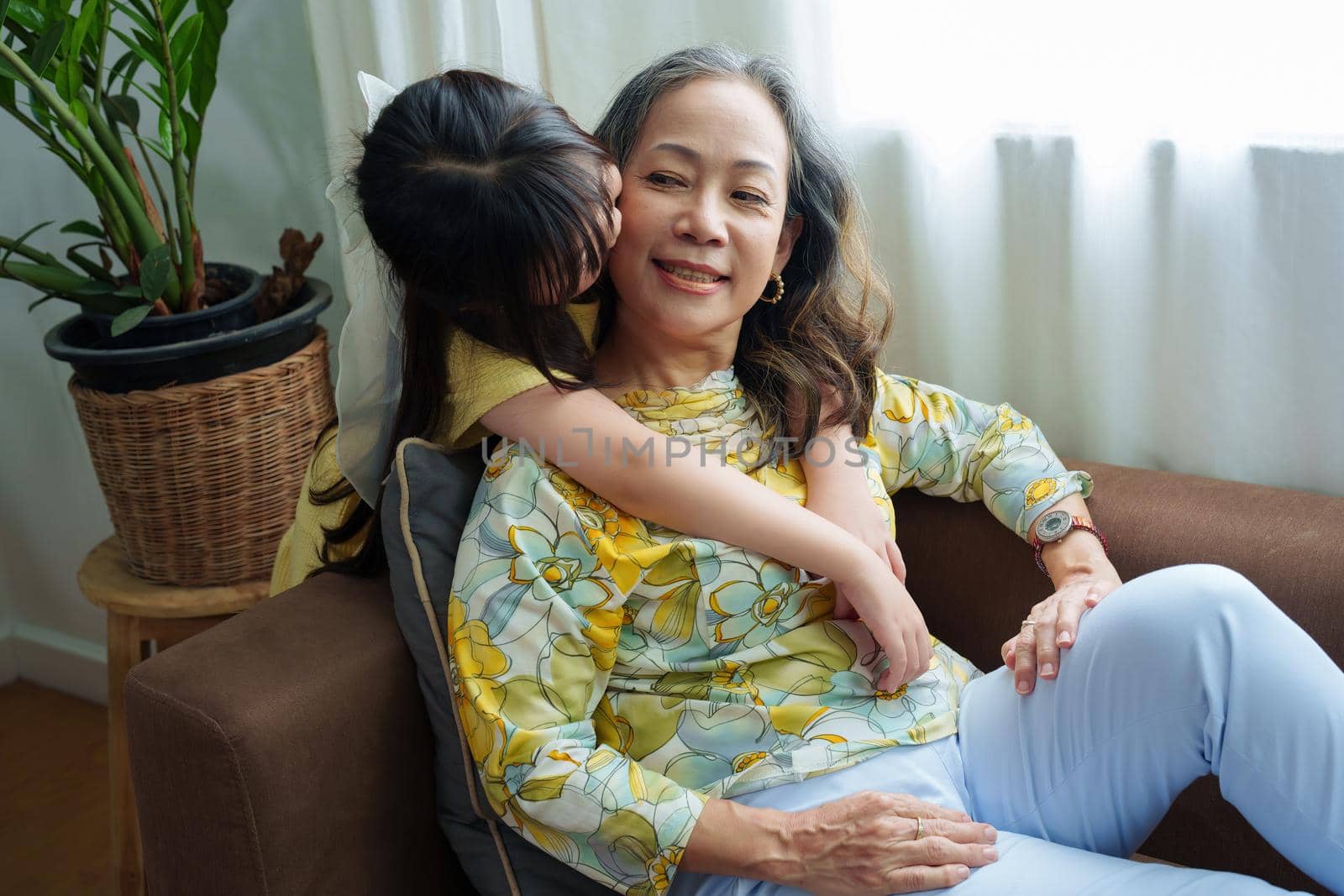 Asian portrait, grandma and granddaughter doing leisure activities and hugging to show their love and care for each other.