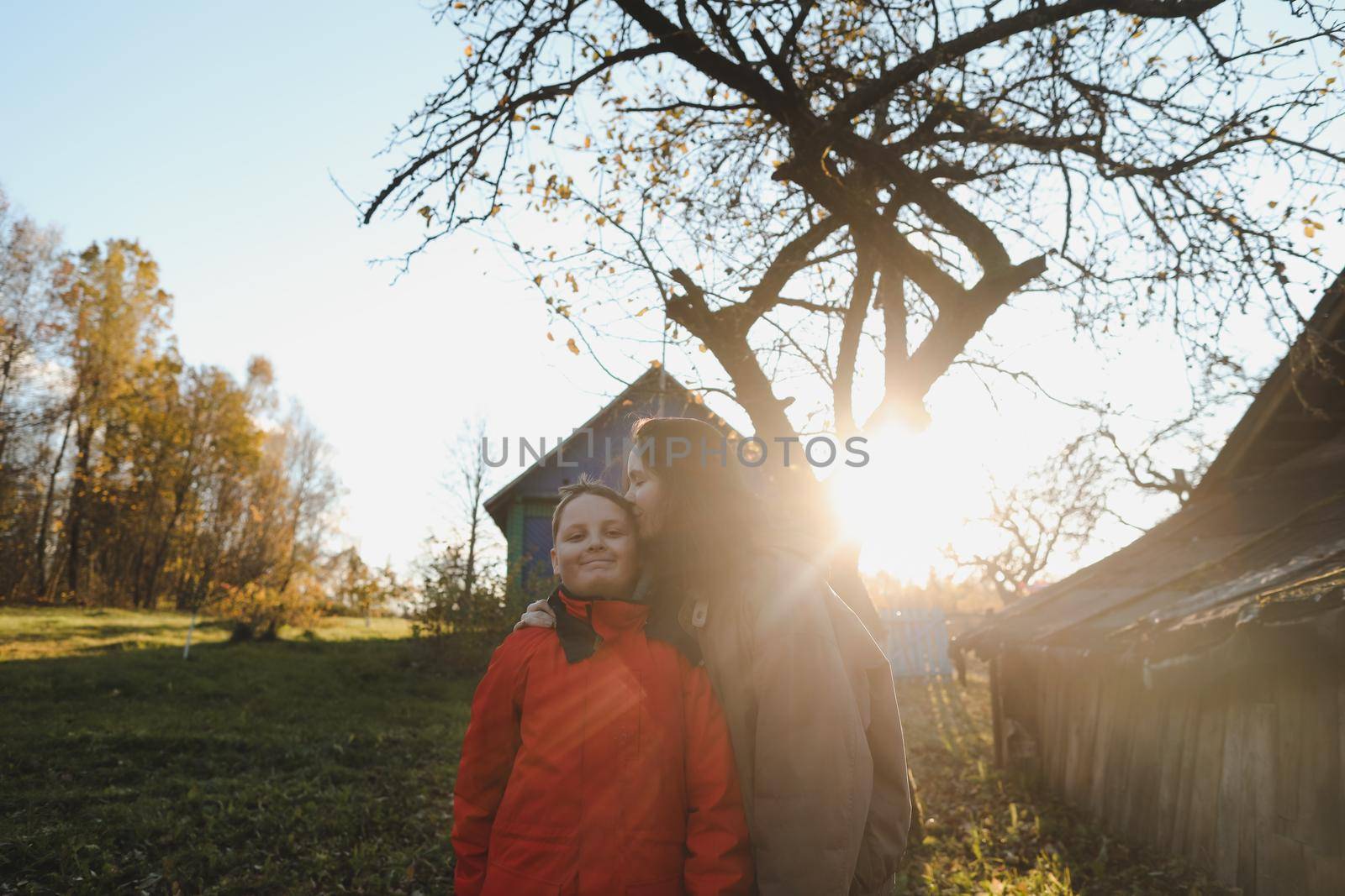 Mother and son outdoors, happy family lifestyle portrait in the park.