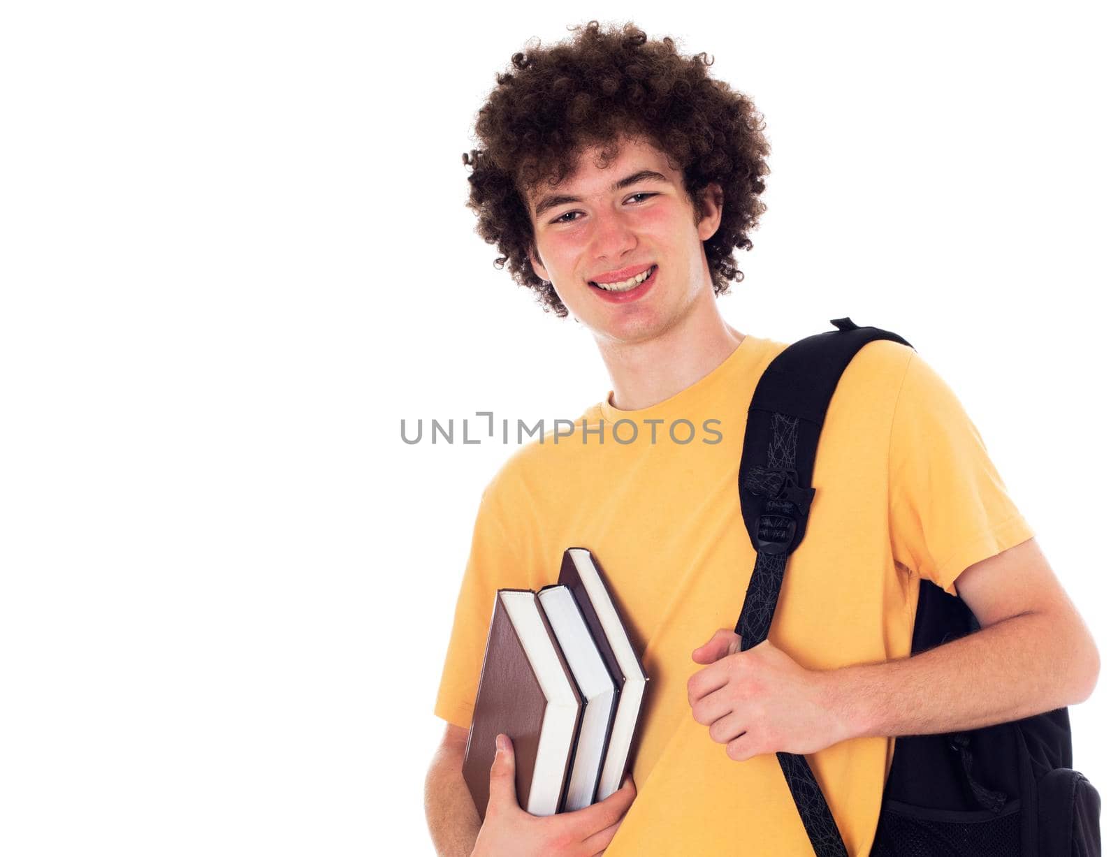 Smiling happy student standing with backpack and books. Isolated on white.