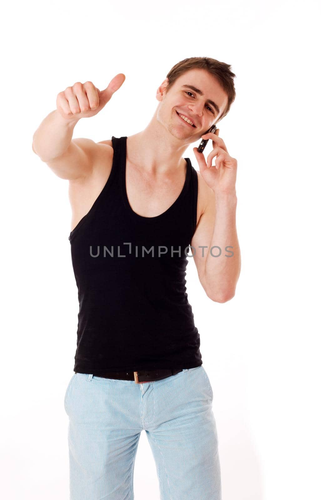 Man with mobile phone giving a thumbs up. Sure he gets good news. Isolated on white.