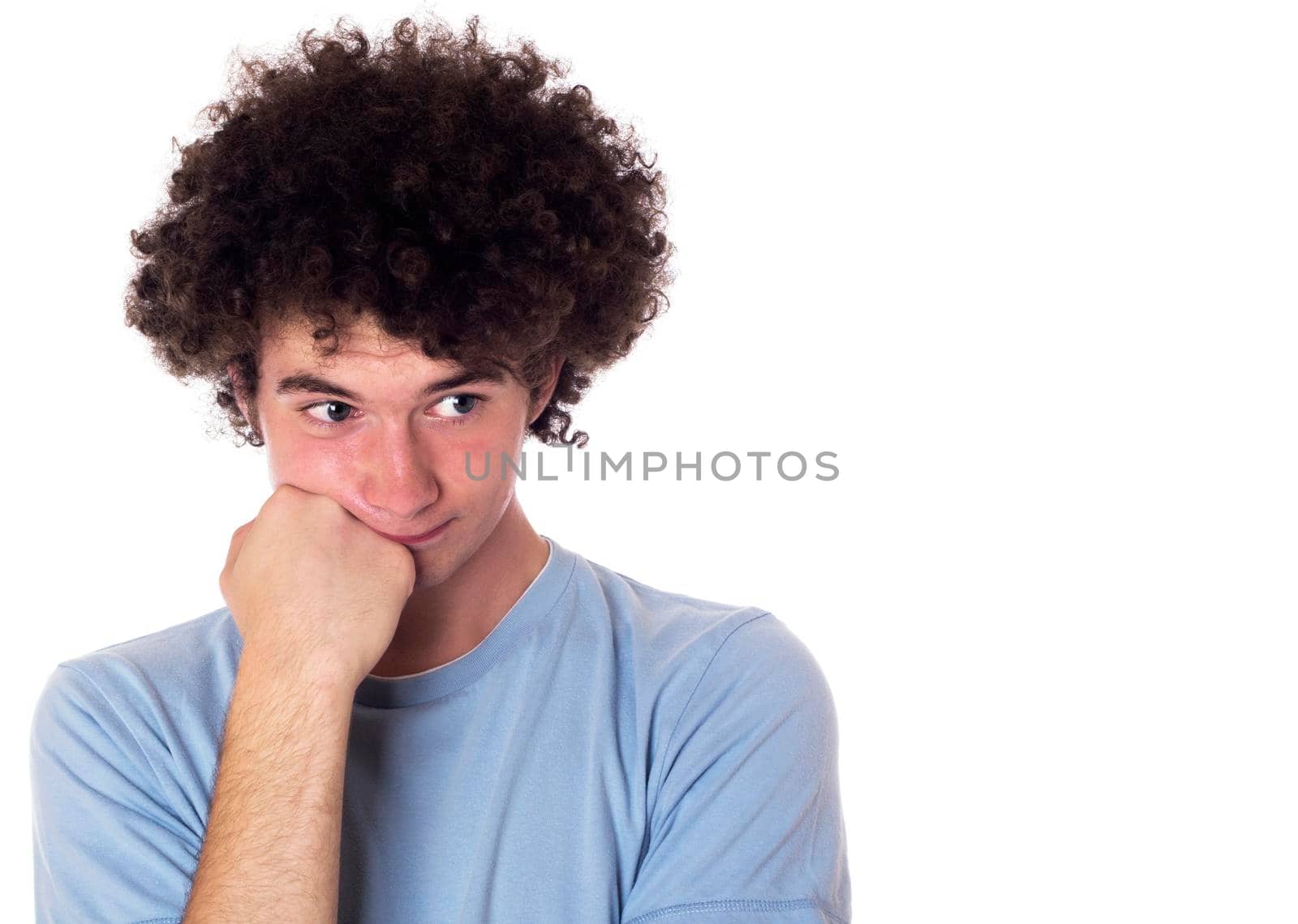 Teenager with a bored look on his face and downcast appearance. Isolated on white.