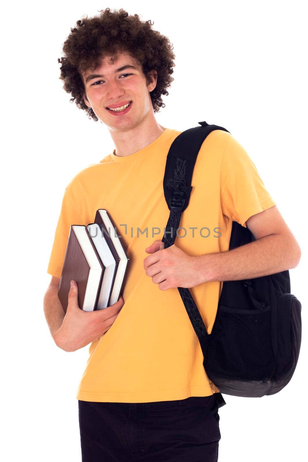 Smiling happy student standing with backpack and books. Isolated on white.