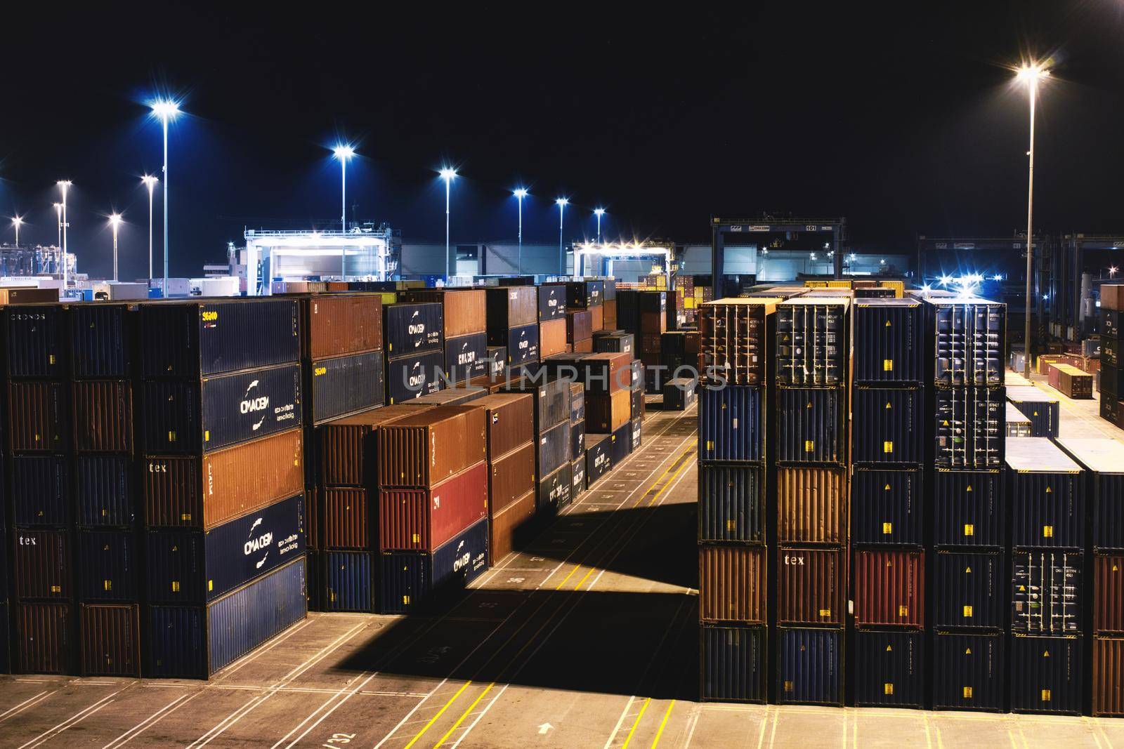 25 April 2022 - Birzebbuga, Malta: Shipping containers containing commercial cargo stacked in a transhipment hub depot at night by tennesseewitney