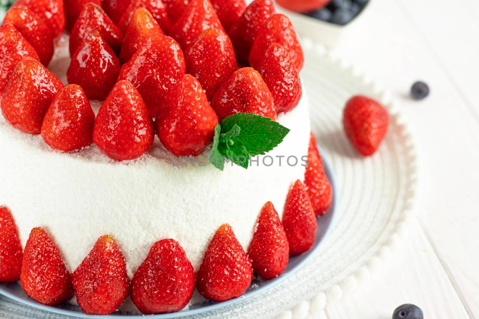 selective focus. Strawberry pie garnished with fresh strawberries. Homemade strawberries cake made from meringue cake and cream with strawberries. Decorated with icing and berries. birthday cake