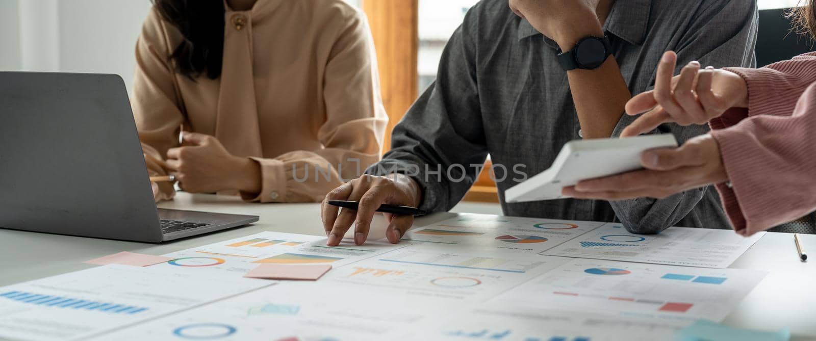 Business People Meeting Design Ideas Concept. Group of Investor diverse brainstorm and pointing at laptop computer on wooden desk