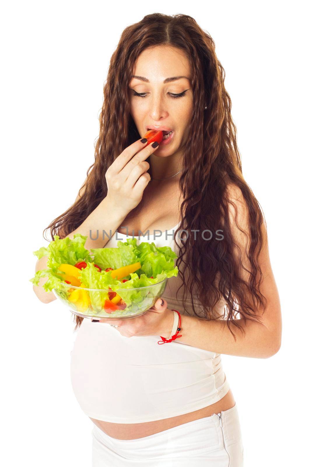 Pregnant woman eating chopped salad, isolated on white.