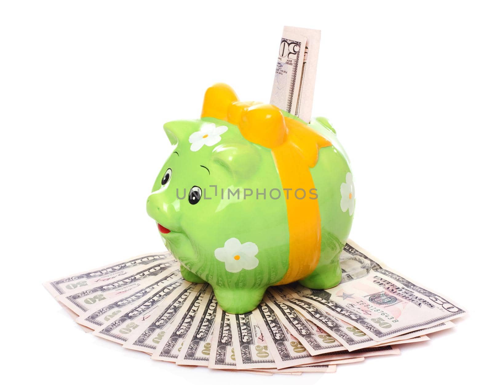 Piggybank full of dollar bills, isolated on white.