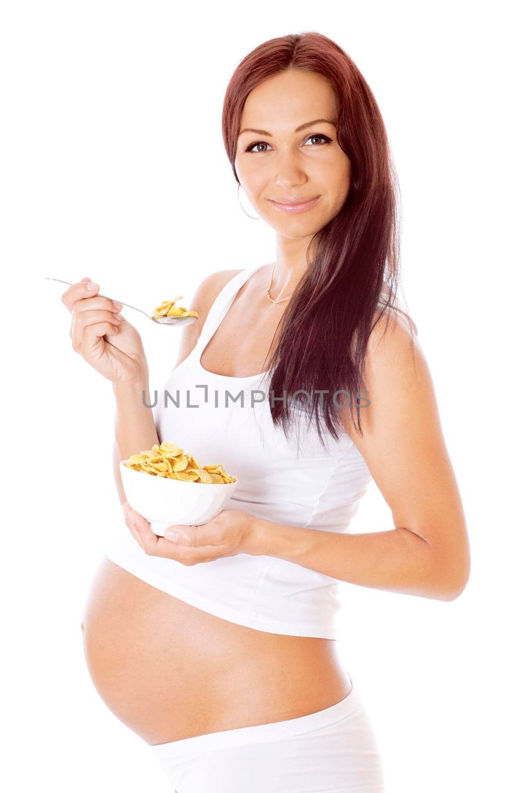 Pregnant woman eating corn flakes, isolated on white.