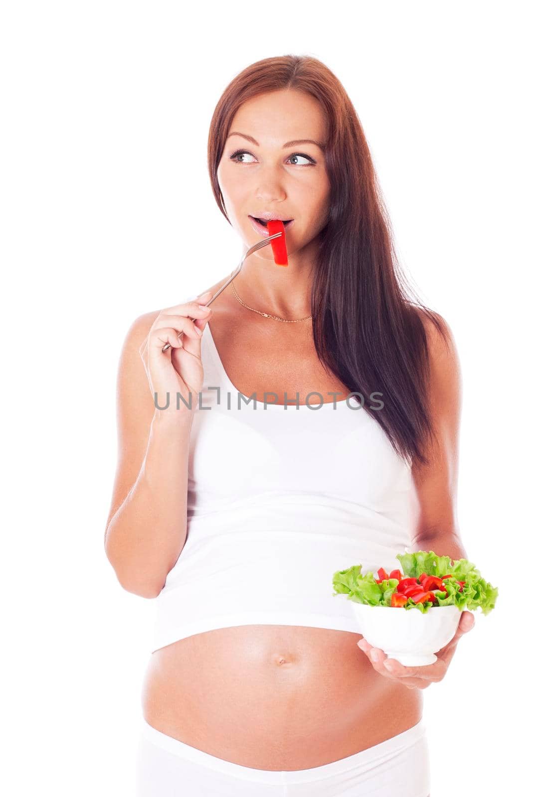 Pregnant woman eating salad. by Jyliana