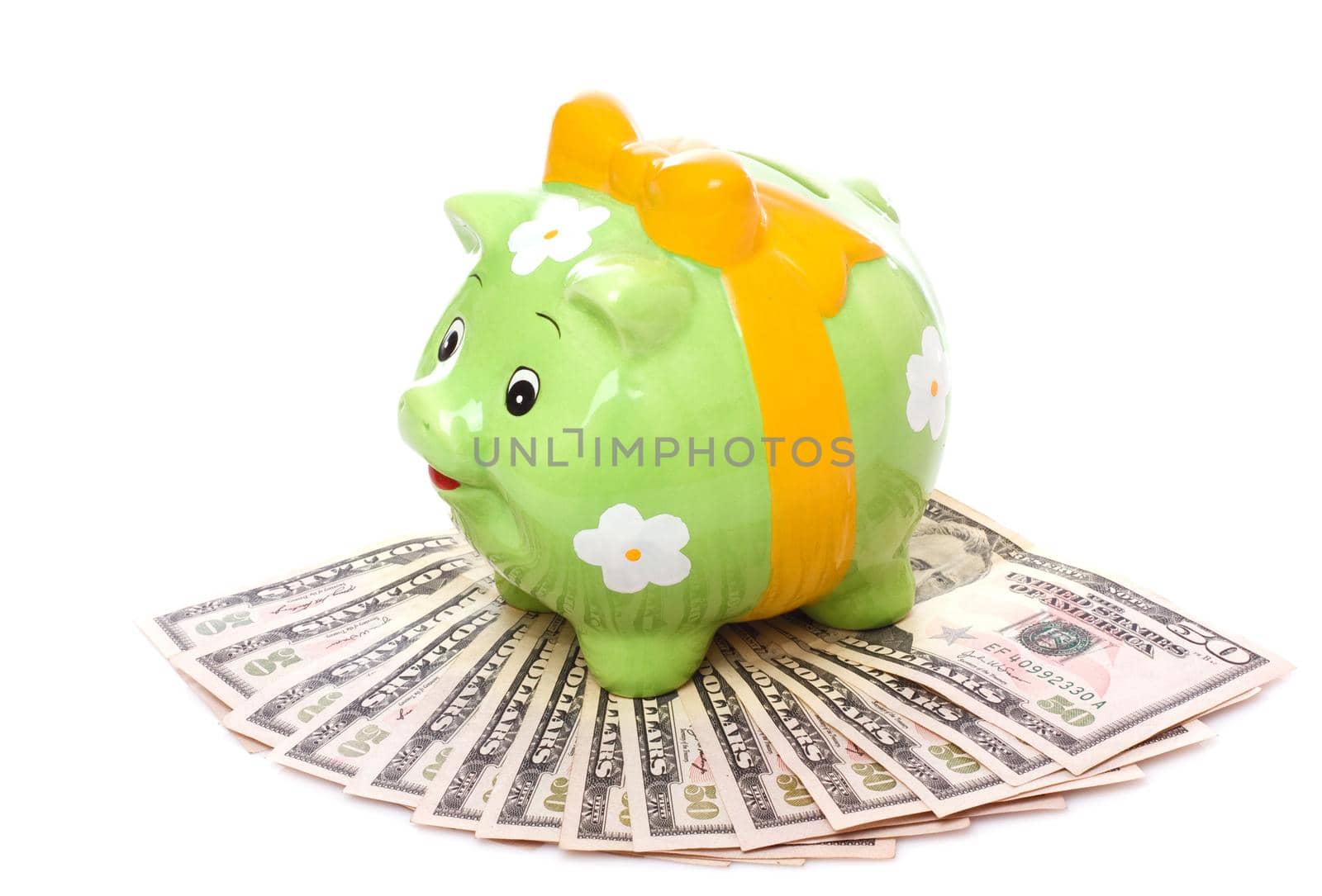 Piggybank full of dollar bills, isolated on white.