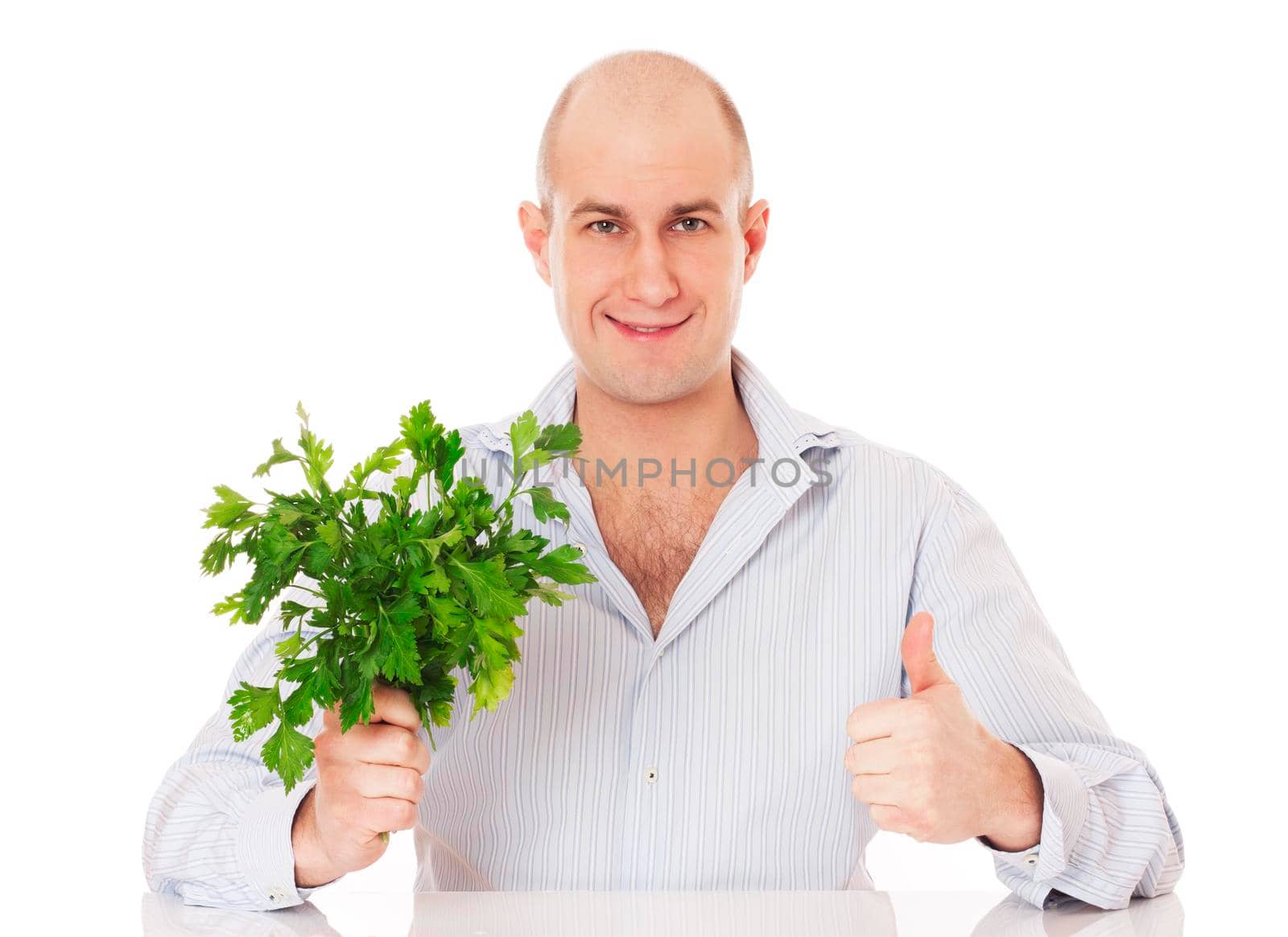 Man with bunch of fresh parsley in a hand. Isolated on white.