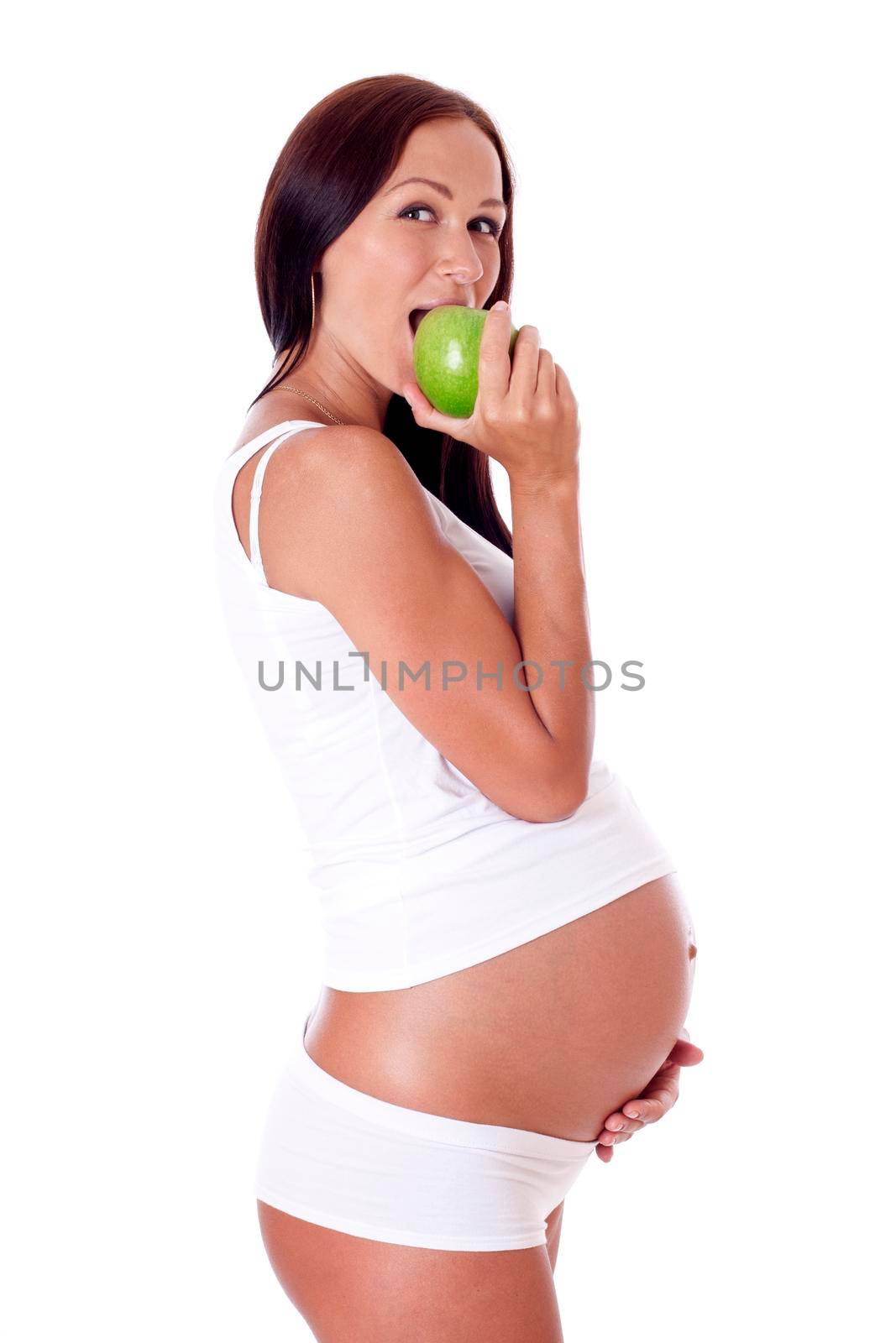 Pregnant woman biting apple, isolated on white