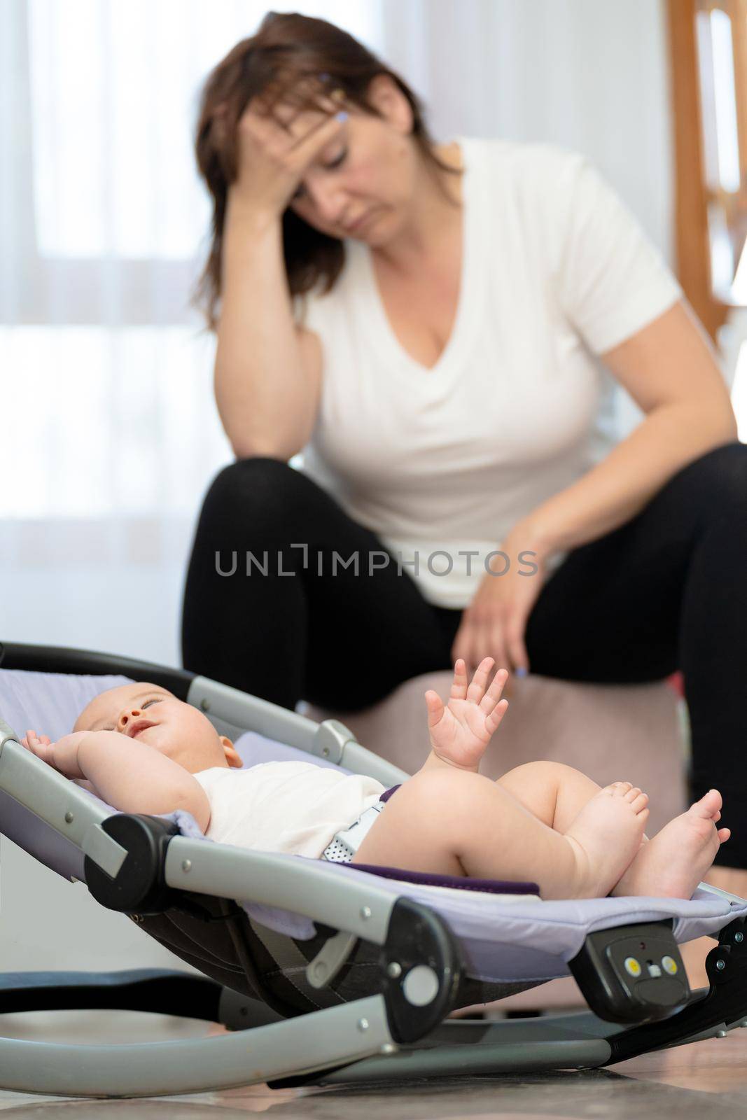 Young woman suffering from postnatal depression at home. High quality photo