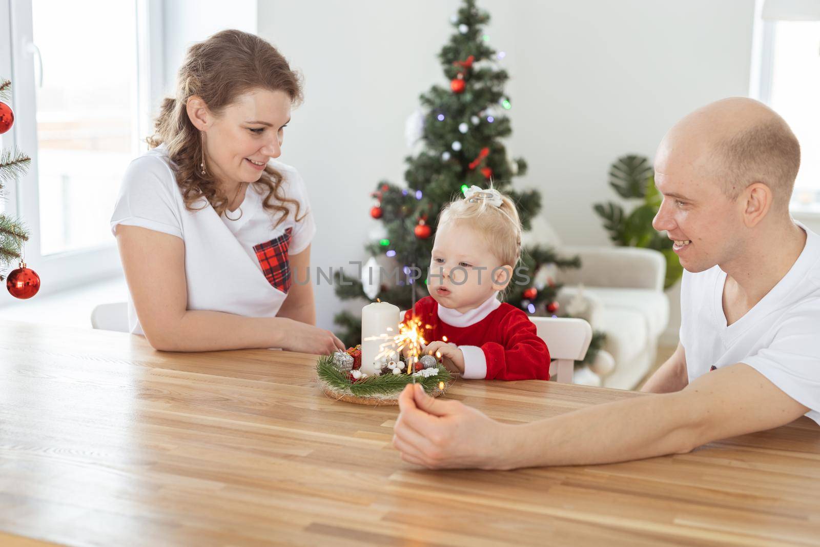 Child girl dressed in christmas dress with cochlear implants having fun at home - hearing aid and innovating technologies for treatment deafness