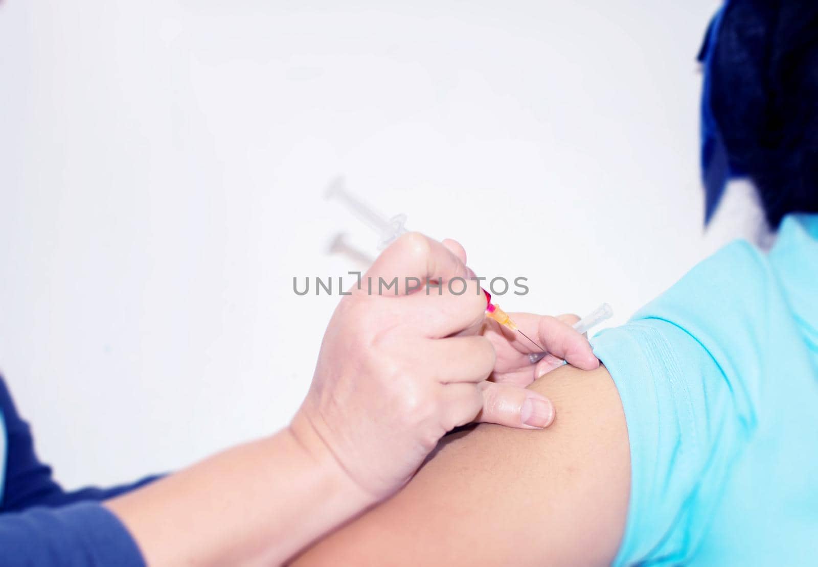 close up Hand of The nurse holding syringe giving a vaccine for a patient.