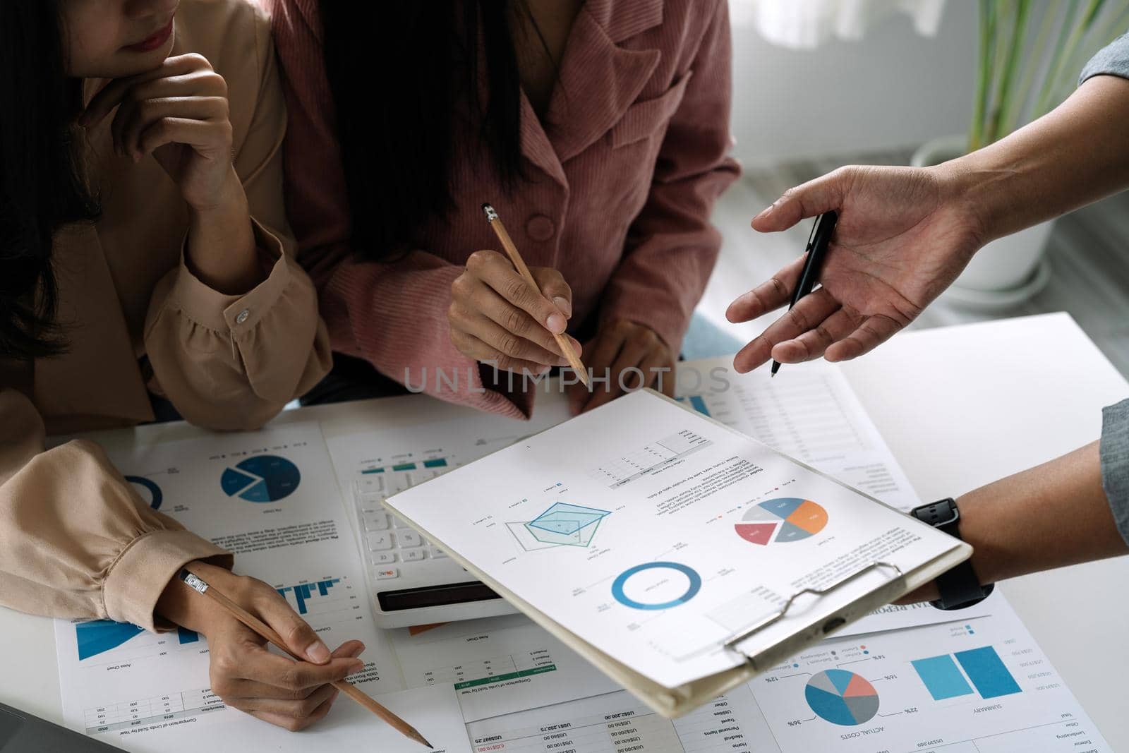 Asian business adviser meeting to analyze and discuss the situation on the financial report in the meeting room.Investment Consultant, Financial advisor and accounting concept.