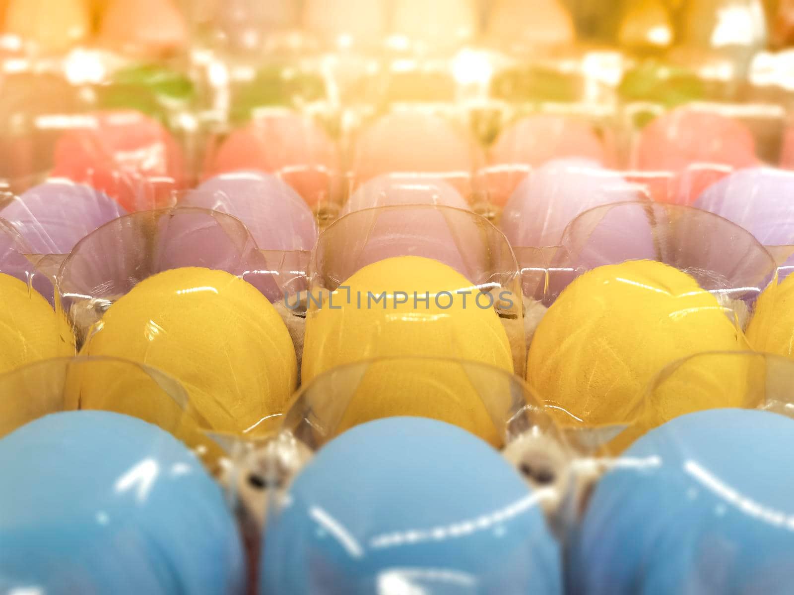 Close up Many colorful eggs fresh from farm pack up in recycle egg tray covered with transparent plastic .