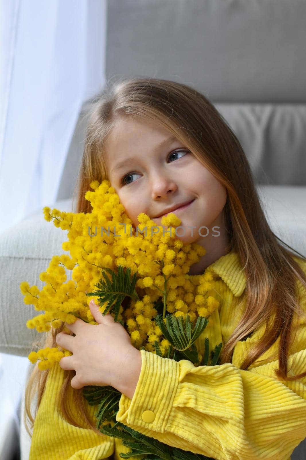 A girl holding mimosa on a white background