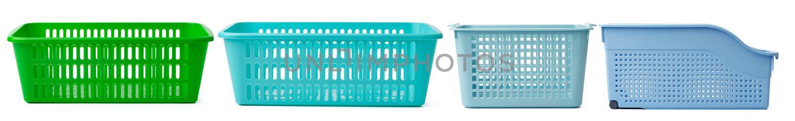 Set of plastic shopping baskets on white background, close up
