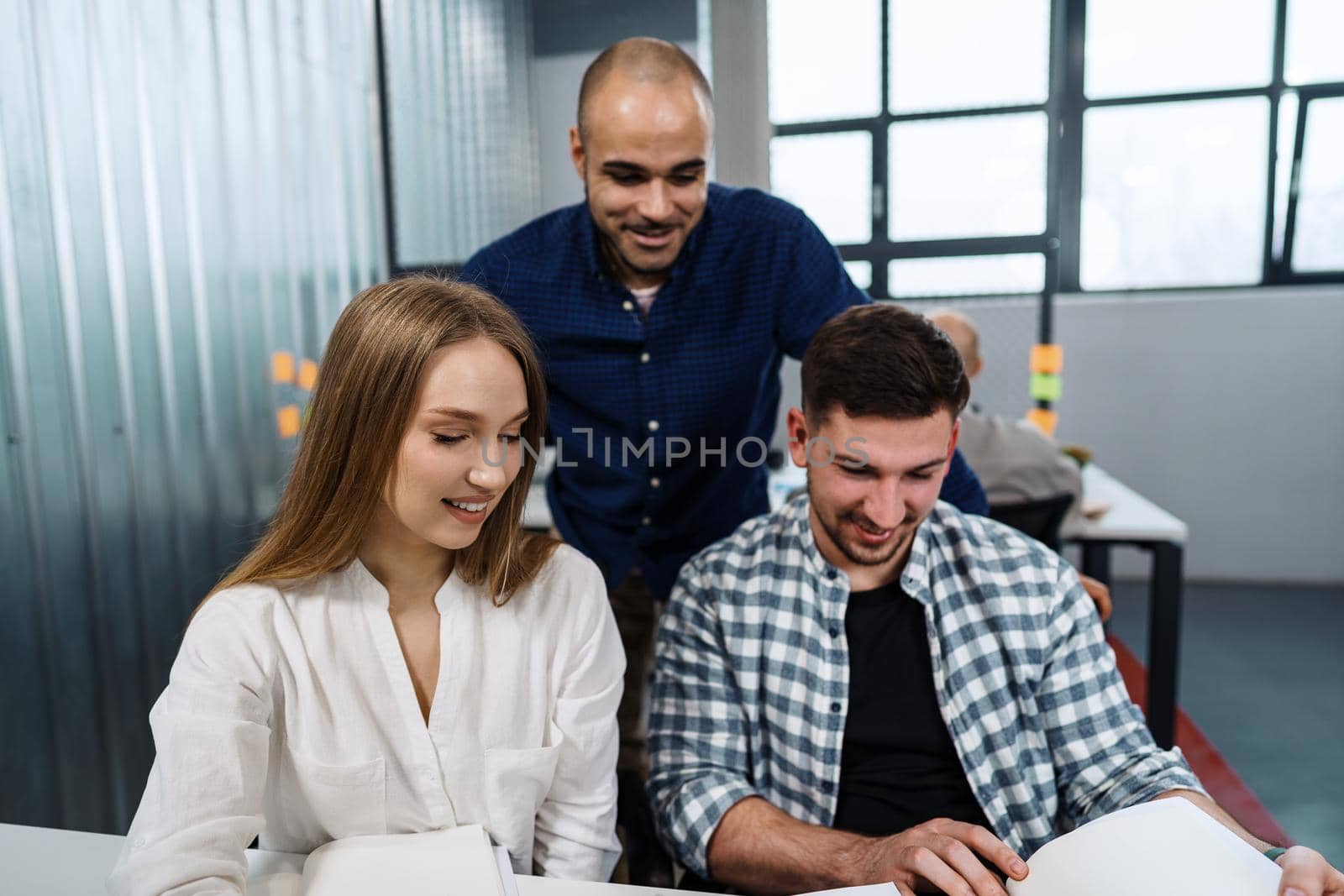 Group of young business people working in office together