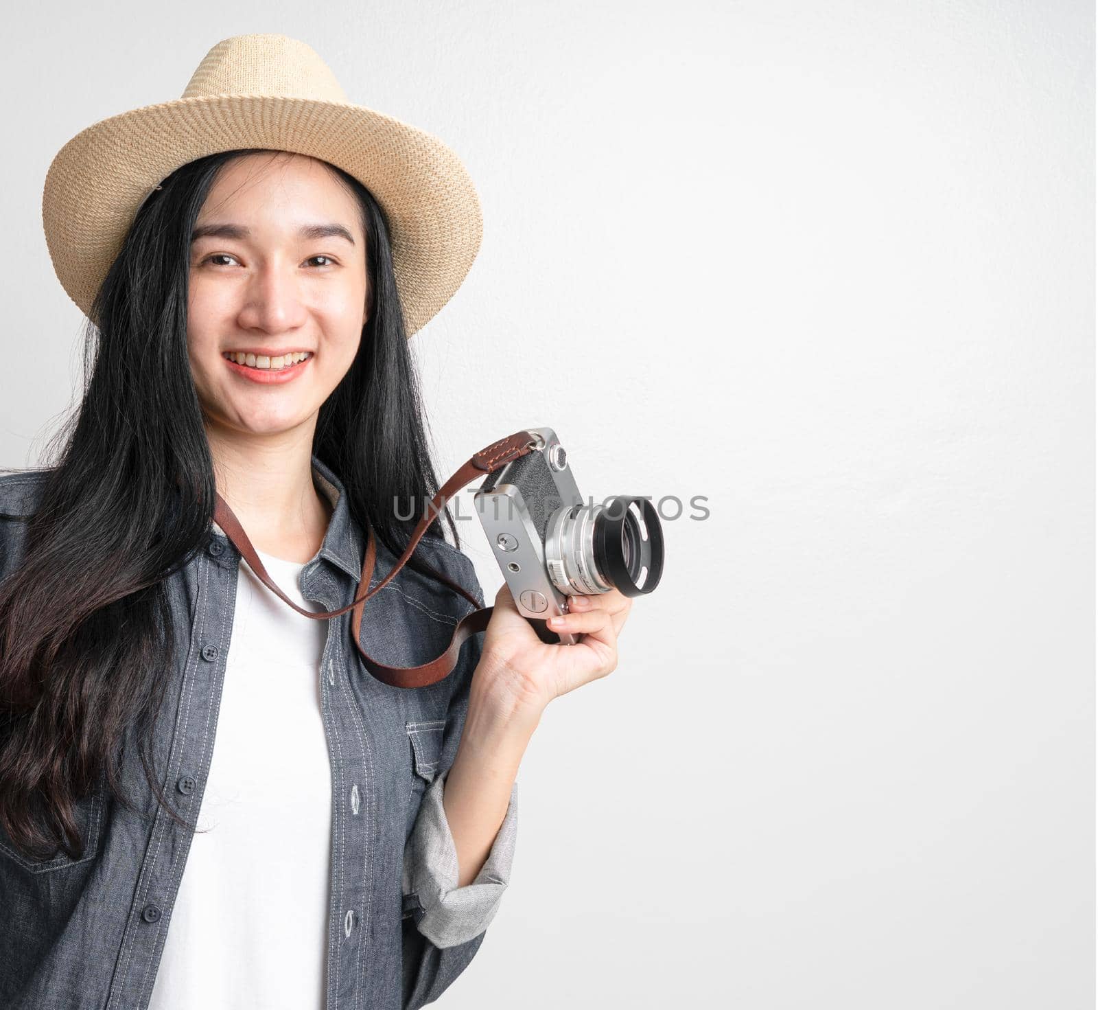 Asian woman holding vintage camera with copy space.  Travel concept