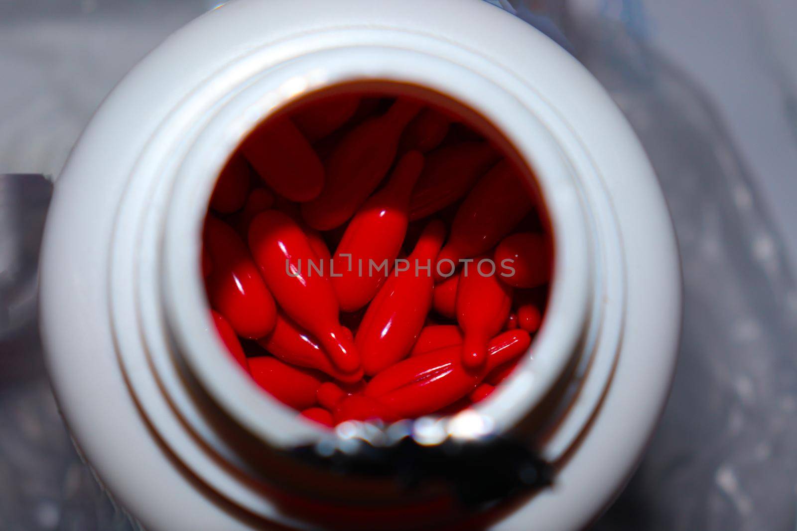 red colored vitamin a capsule stock by jahidul2358
