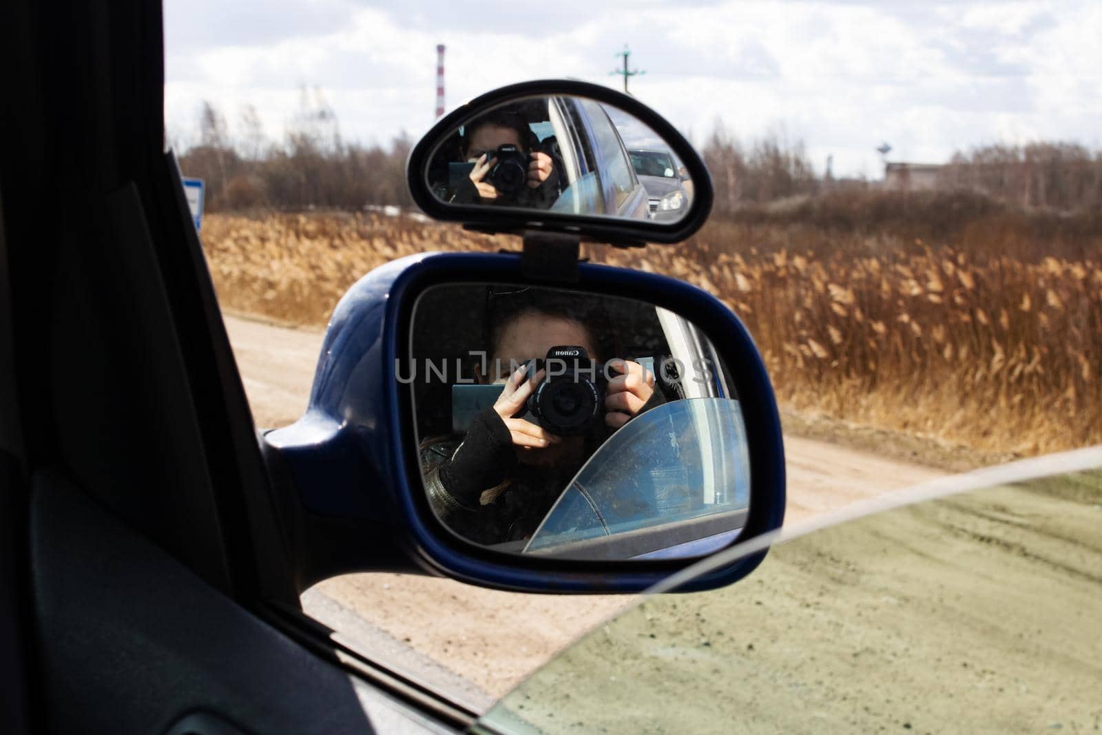 Belarus, Polotsk - 10 april, 2022: Reflection of camera in side mirror of the car by Vera1703