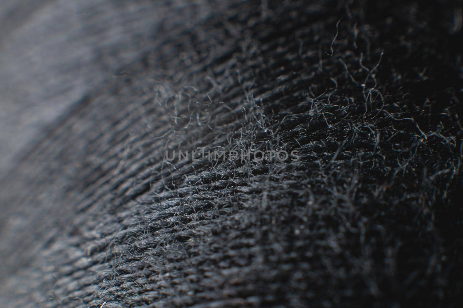 Black thread spool in macro extreme close-up. clothing industry.