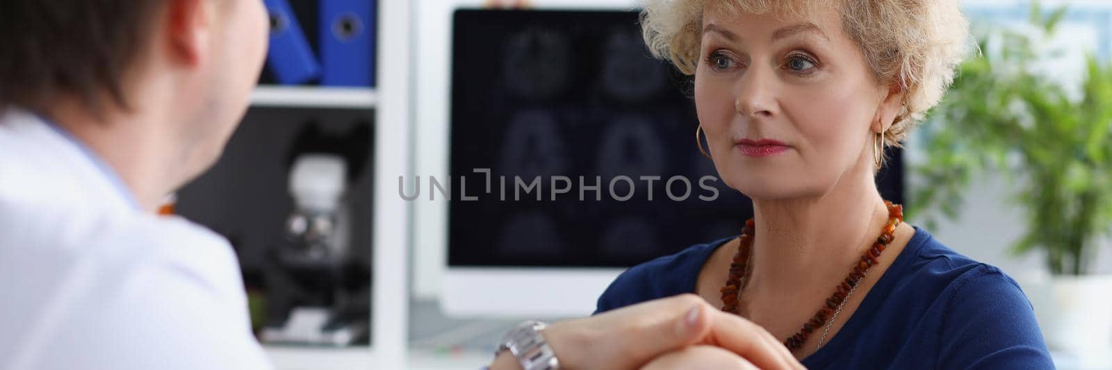 Portrait of professional doctor hold patients hand and calm down after appointment. Senior woman in doctors cabinet, checkup health. Medicine, help concept