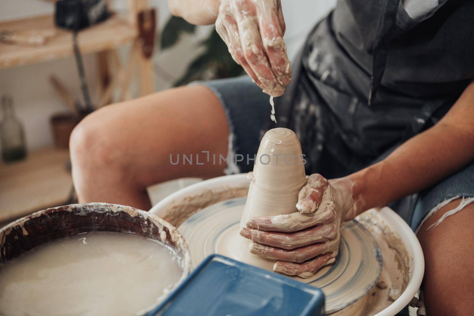 Process of Creating Clay Pot, Unrecognisable Female Master Working on Pottery Wheel in Studio