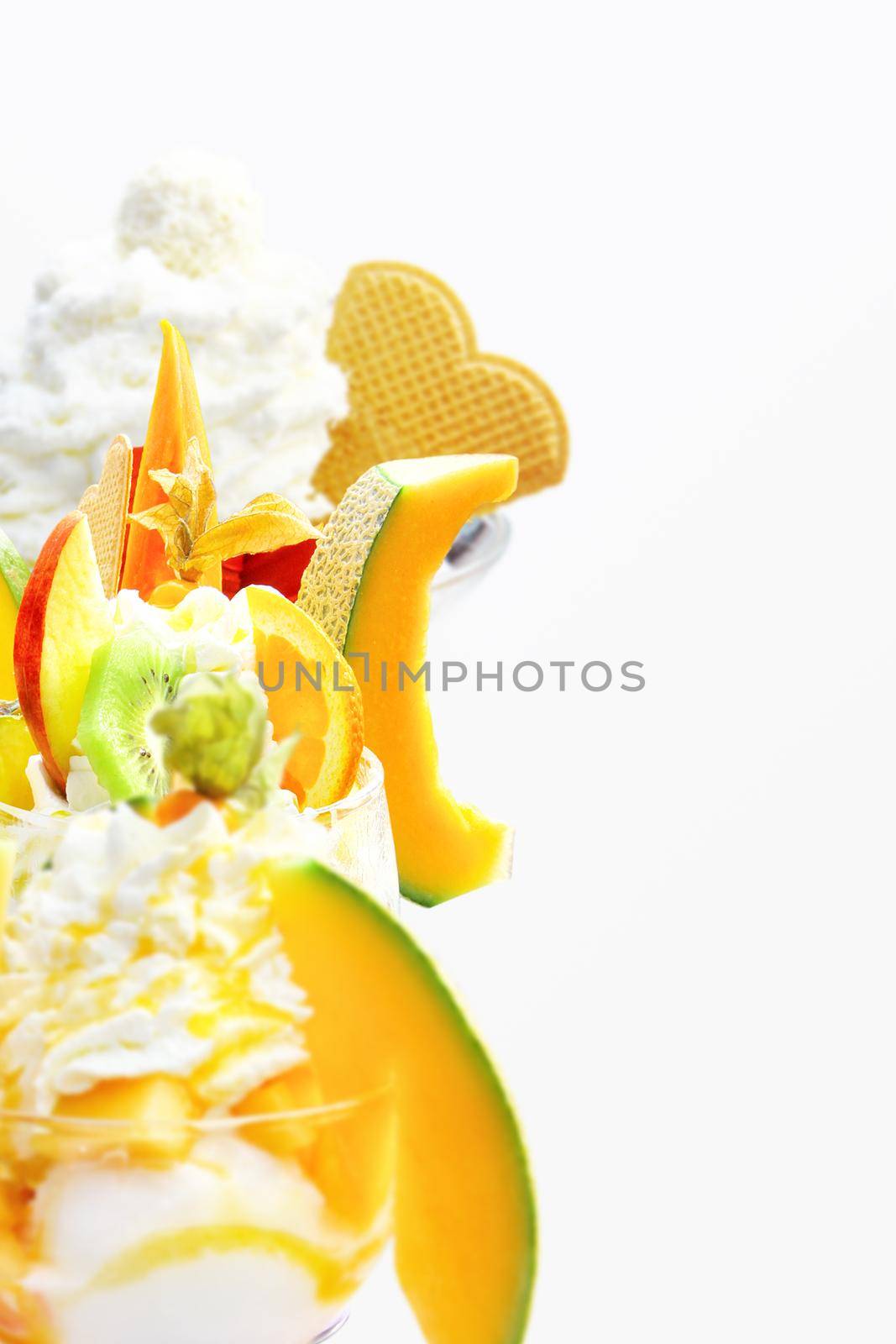 Delicious ice cream with melon and papaya. Healthy summer food concept. by Taut