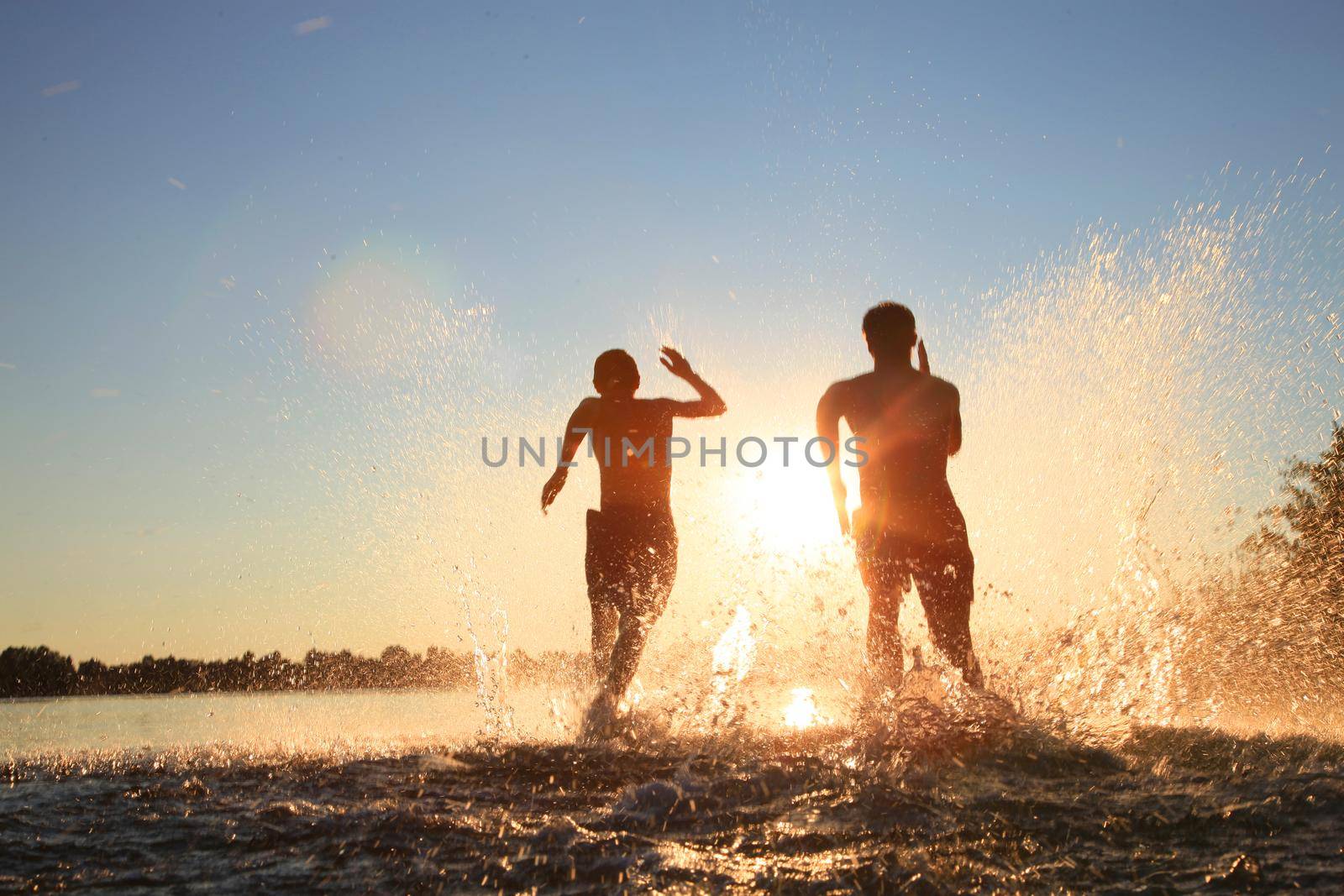 Group of friends having fun on the beach. by Taut