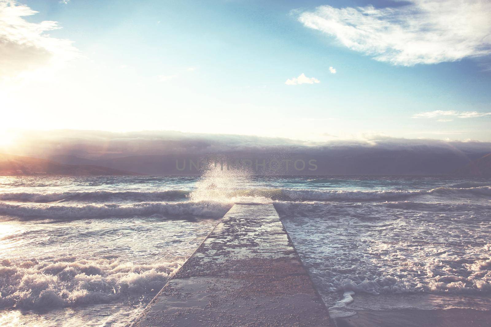 Feeling of freedom concept. Big waves beats against the pier.