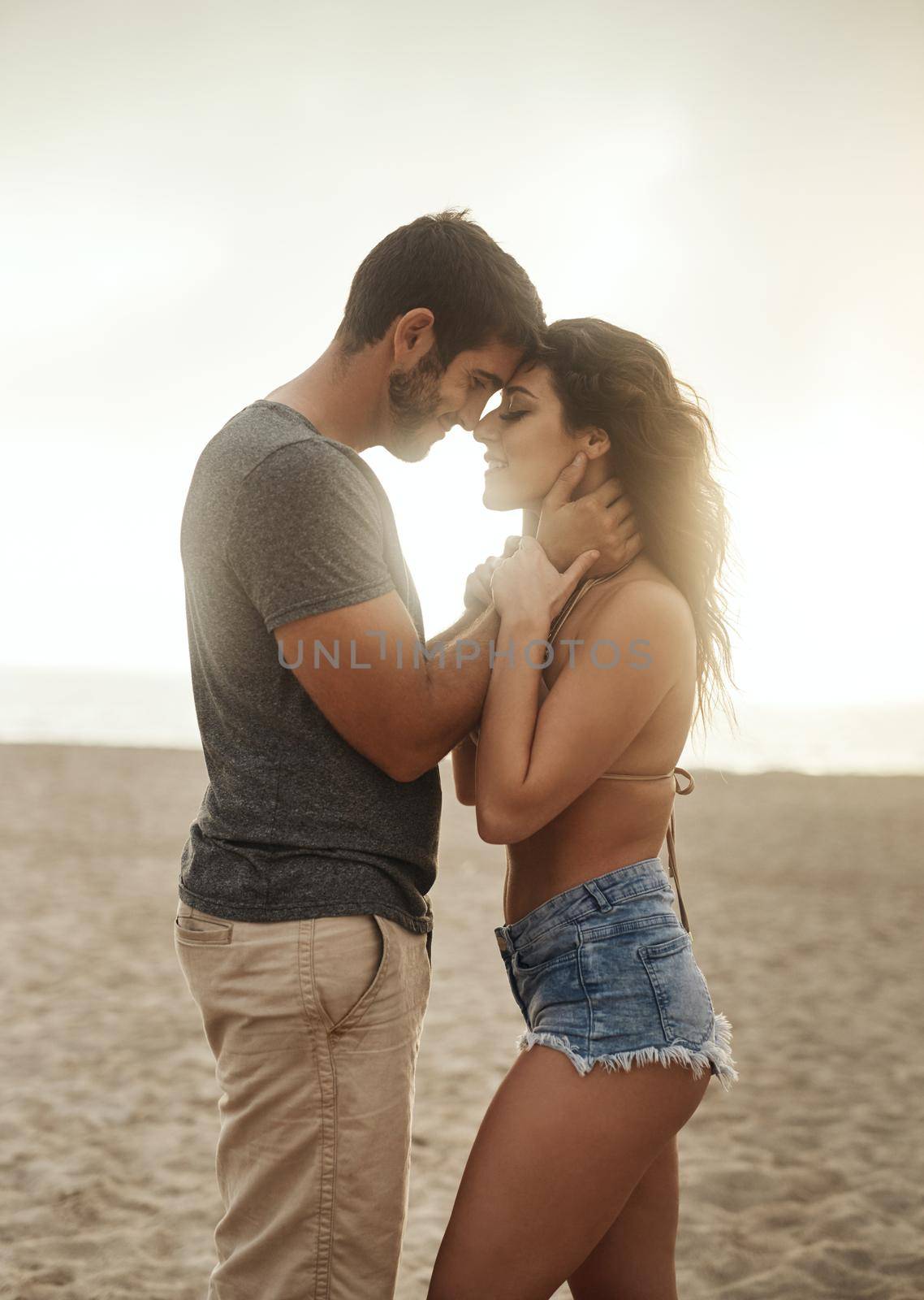 Nothing inspires love like paradise. Shot of a young couple spending a romantic day at the beach. by YuriArcurs