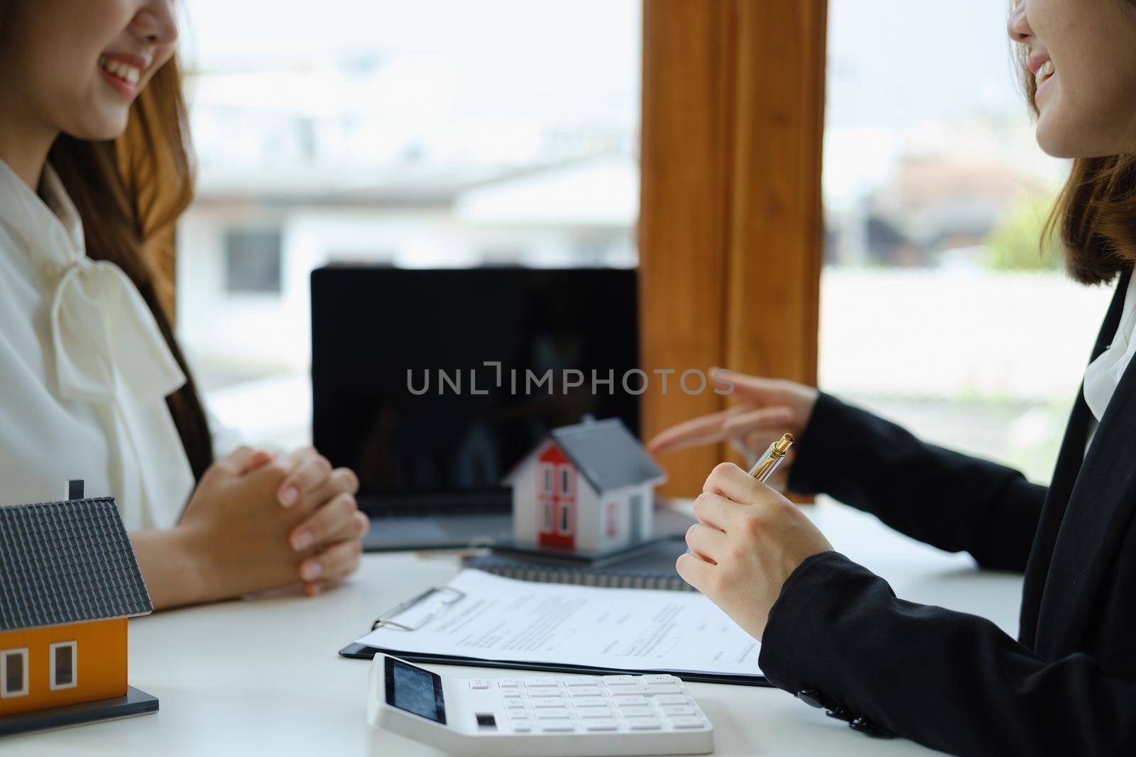 Guarantee, mortgage, agreement, contract, signed, real estate agent pointing to documents for customers to read the agreement before signing important documents.