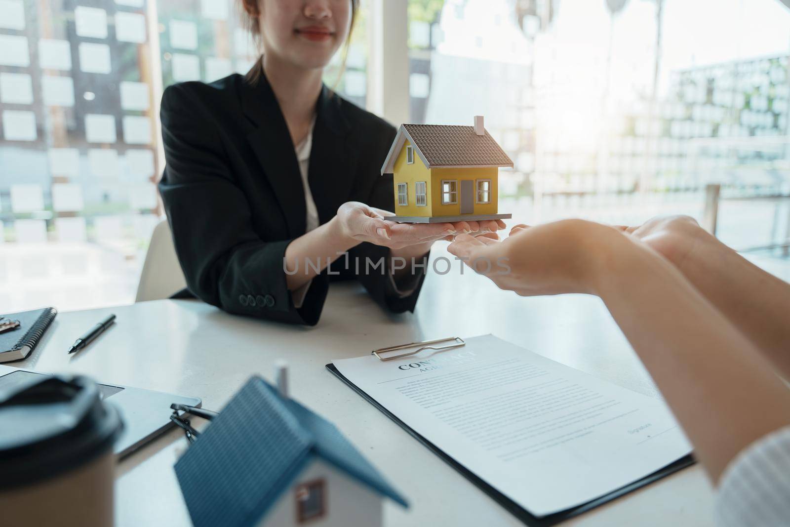 Guarantee, mortgage, agreement, contract, sign, real estate agent delivers the house to the customer after signing important contract documents by Manastrong