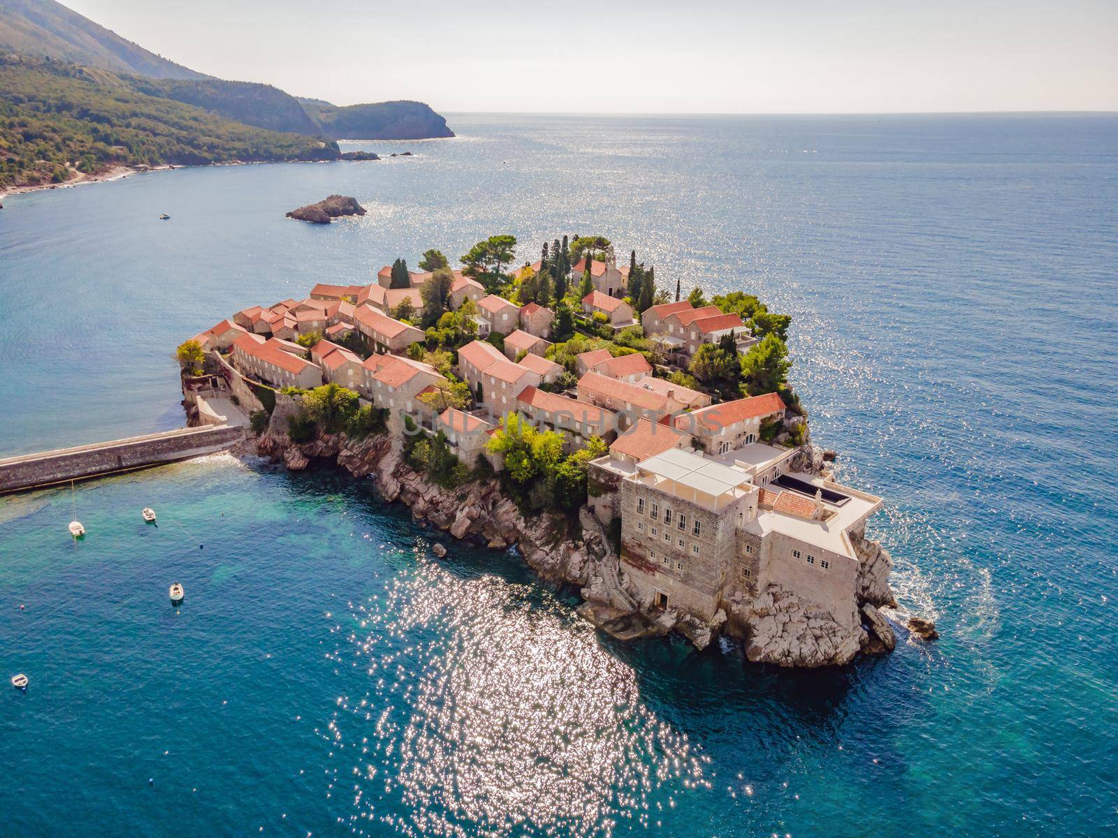 Aerophotography. View from flying drone. Panoramic view of Sveti Stefan island in Budva in a beautiful summer day, Montenegro. Top View. Beautiful destinations.