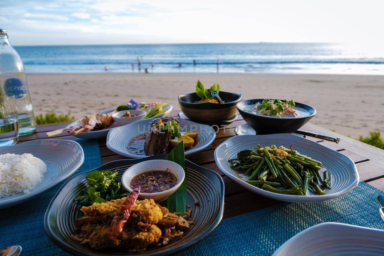 Thai food on a table on the beach in Thailand by fokkebok