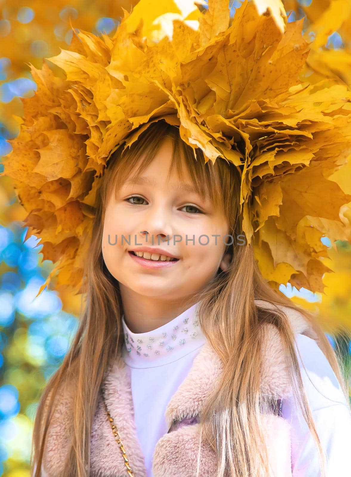 Children in the park with autumn leaves. Selective focus. by yanadjana