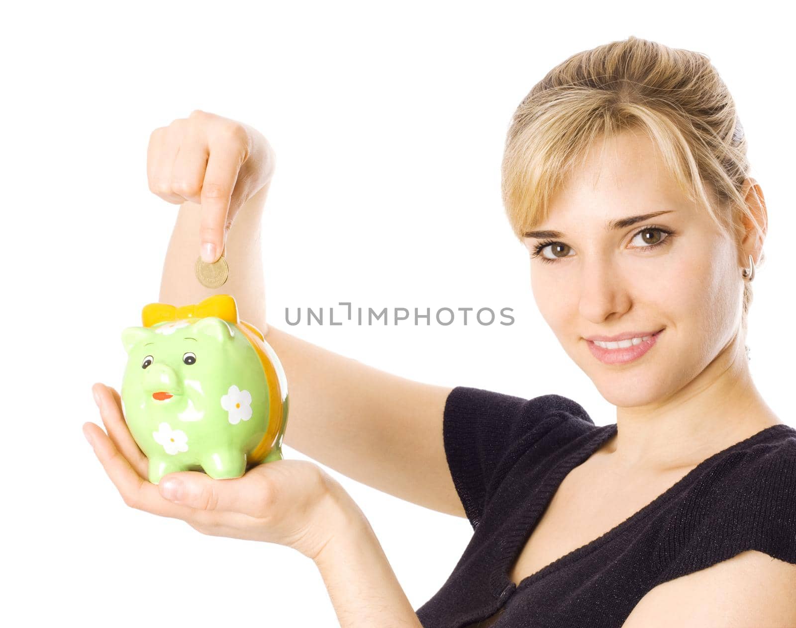 Woman holding piggybank and putting money in it, isolated on white