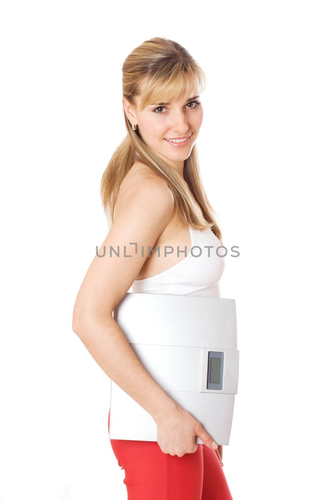 Fit young woman holding a scale, isolated on white