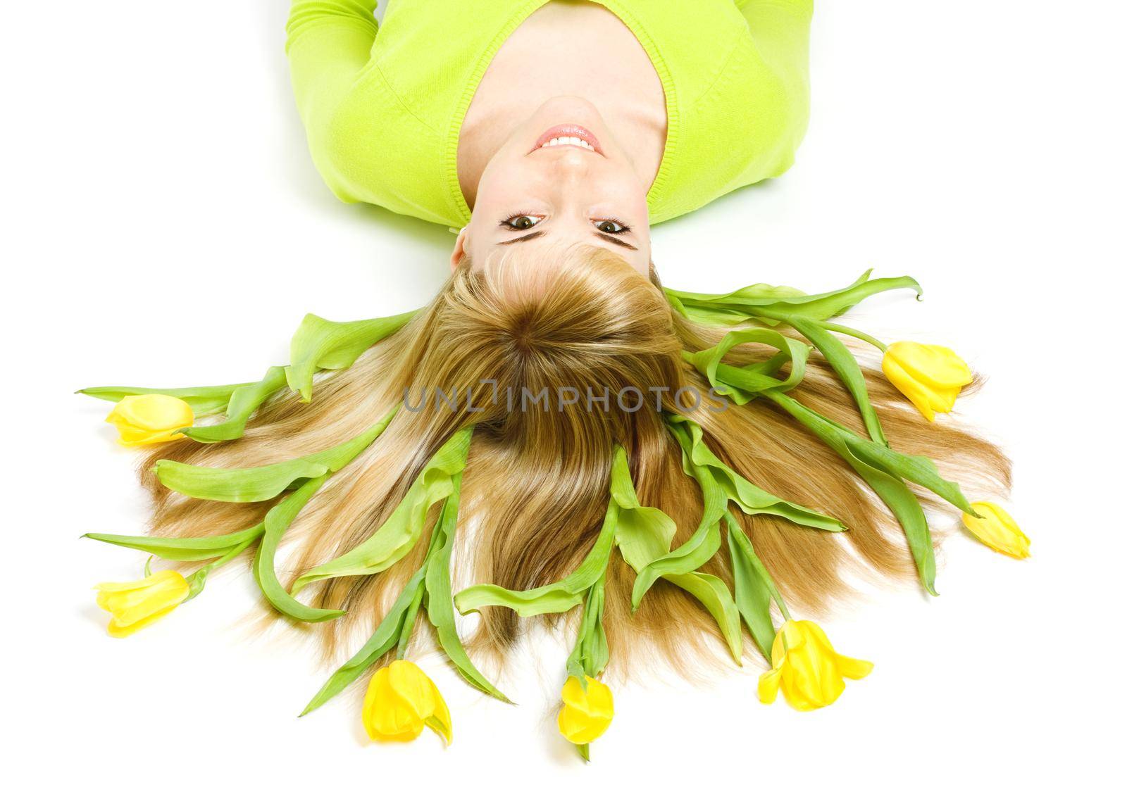 Smiling woman with bouquet of tulips in her hair, isolated on white