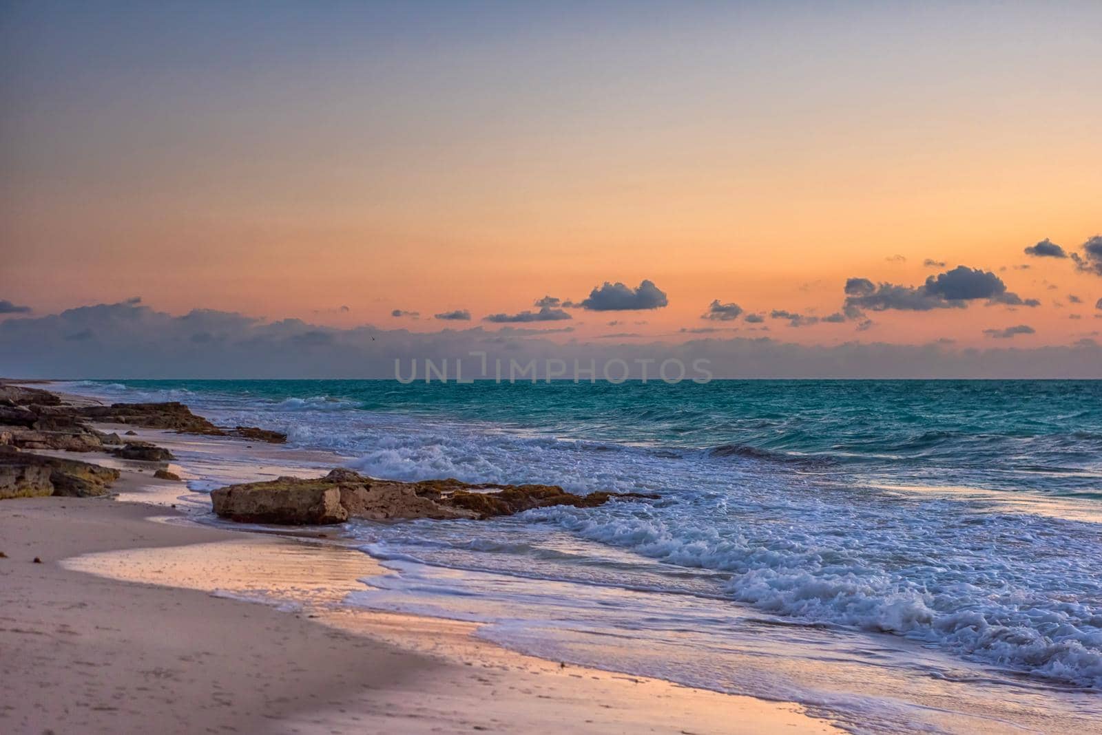 Sunset on the Caribbean Sea. Clear sky with small clouds. Clear weather.