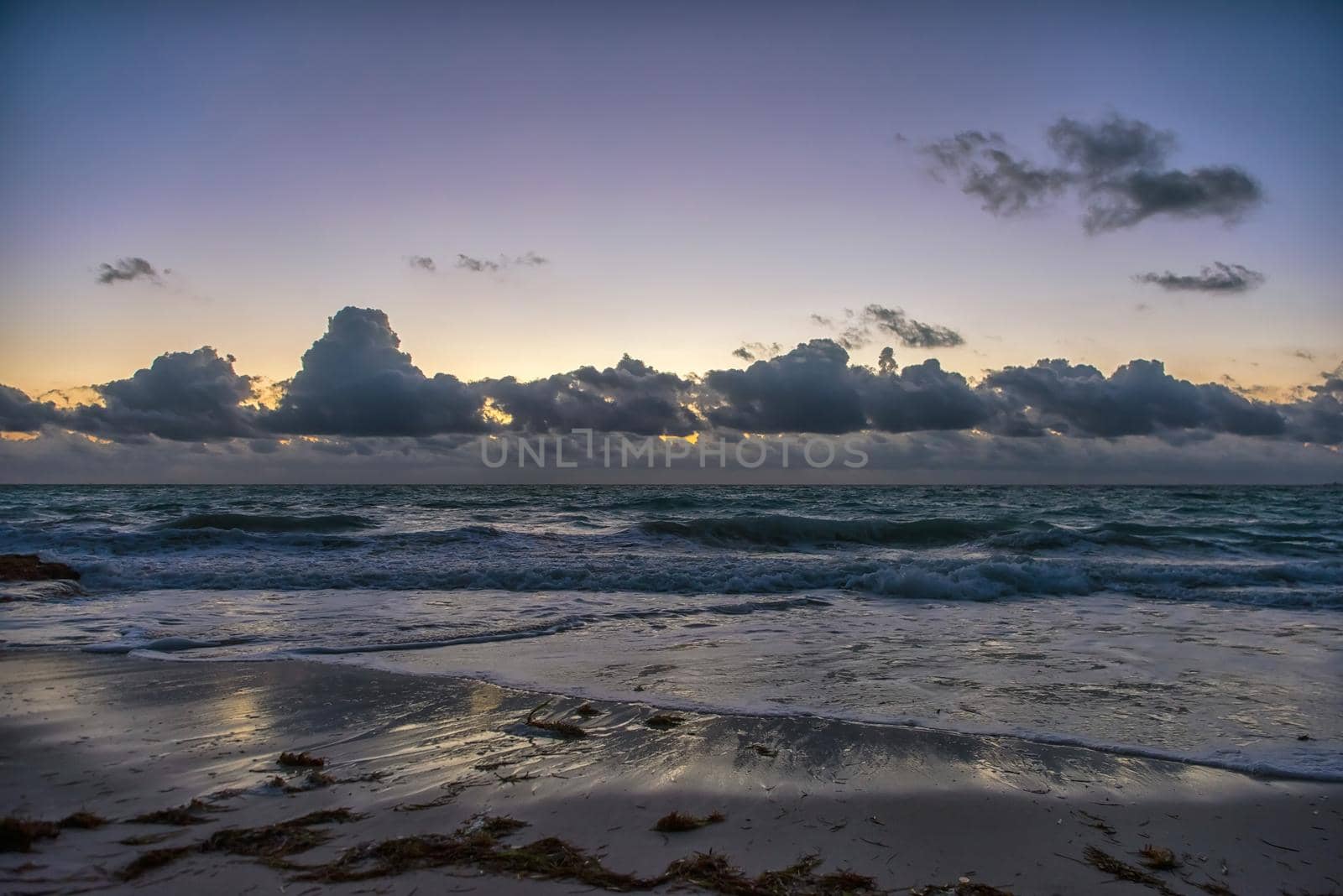 Sunset on the Caribbean Sea. Clear sky with small clouds. Clear weather.