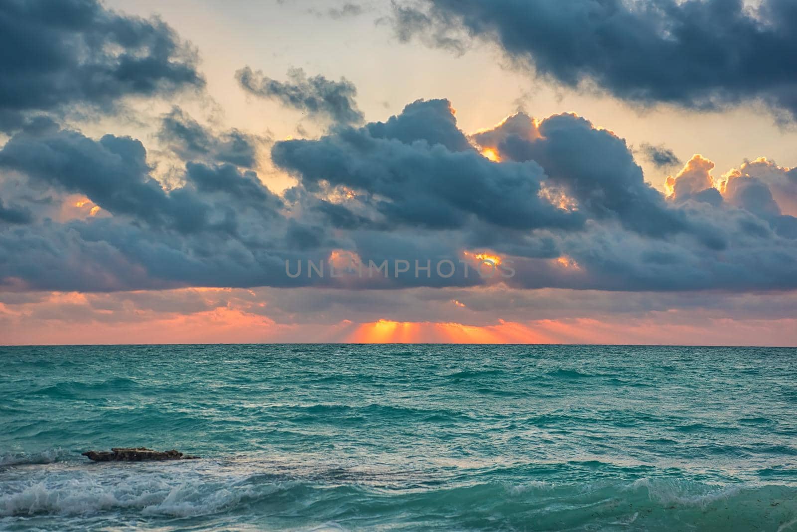 Sunset on the Caribbean Sea. Clear sky with small clouds. Clear weather.