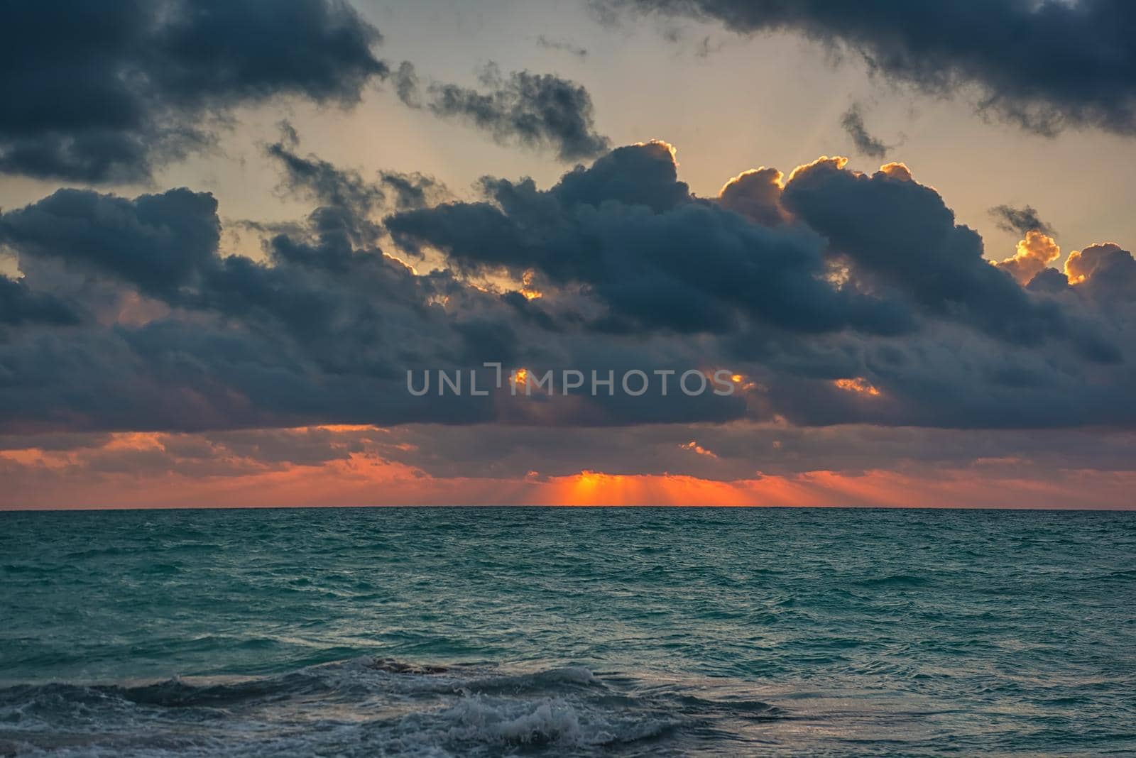 Sunset on the Caribbean Sea. Clear sky with small clouds. Clear weather.