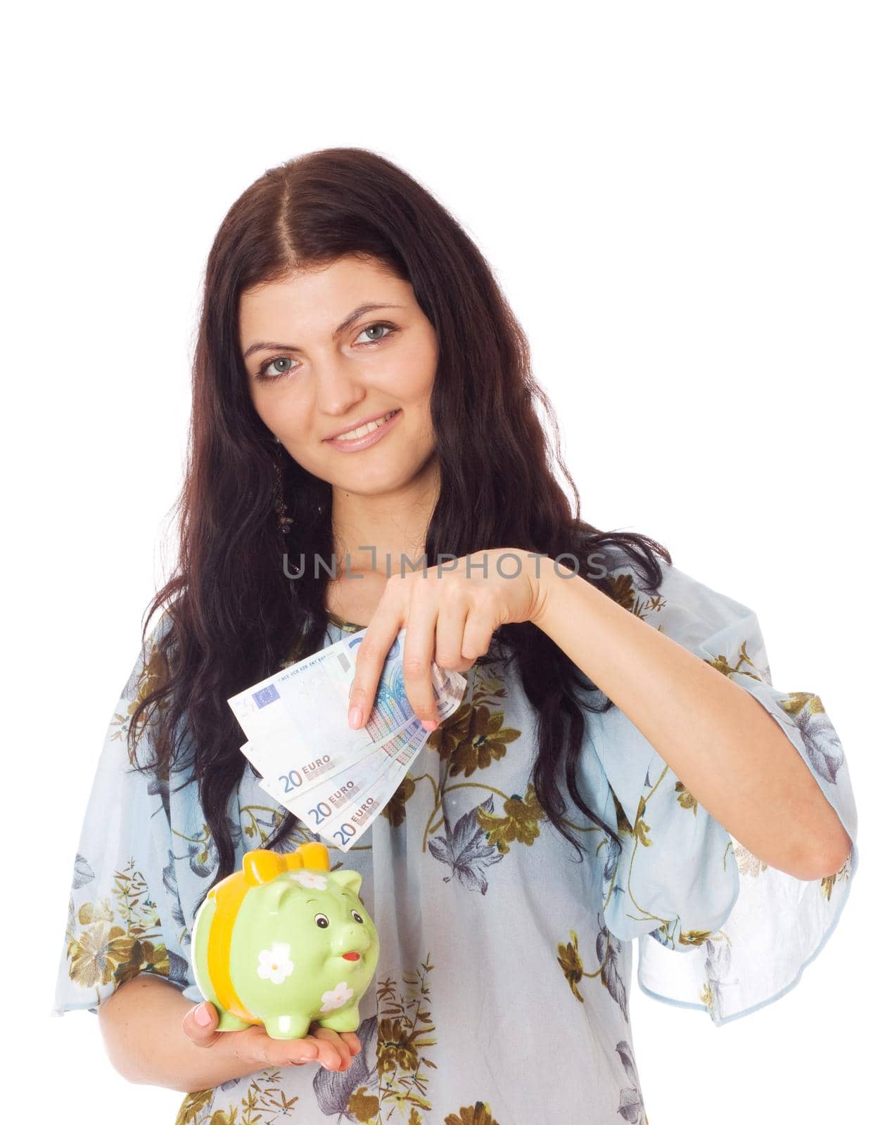 Woman holding piggybank and putting money in it, isolated on white.