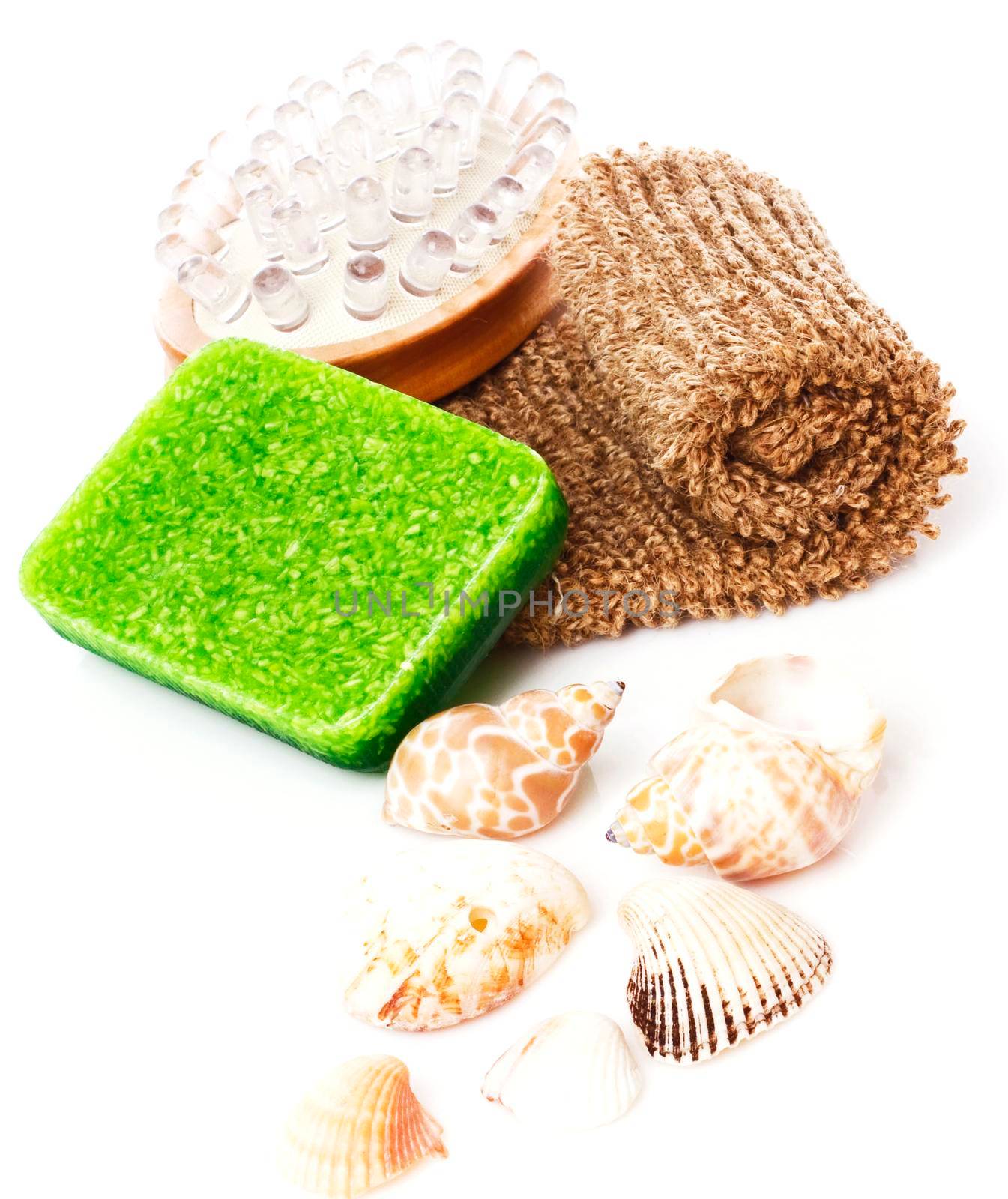 Bathroom composition with natural soap, bast whisp and seashells, isolated.