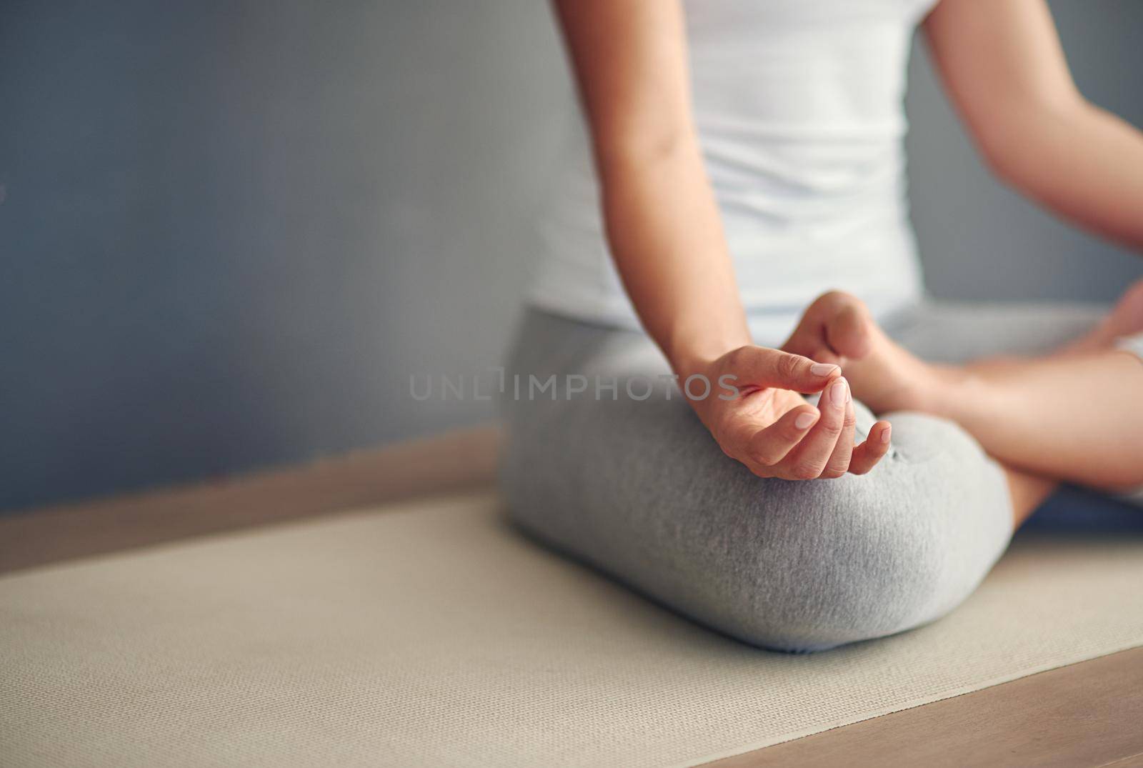 Cropped shot of a young woman practicing yoga.