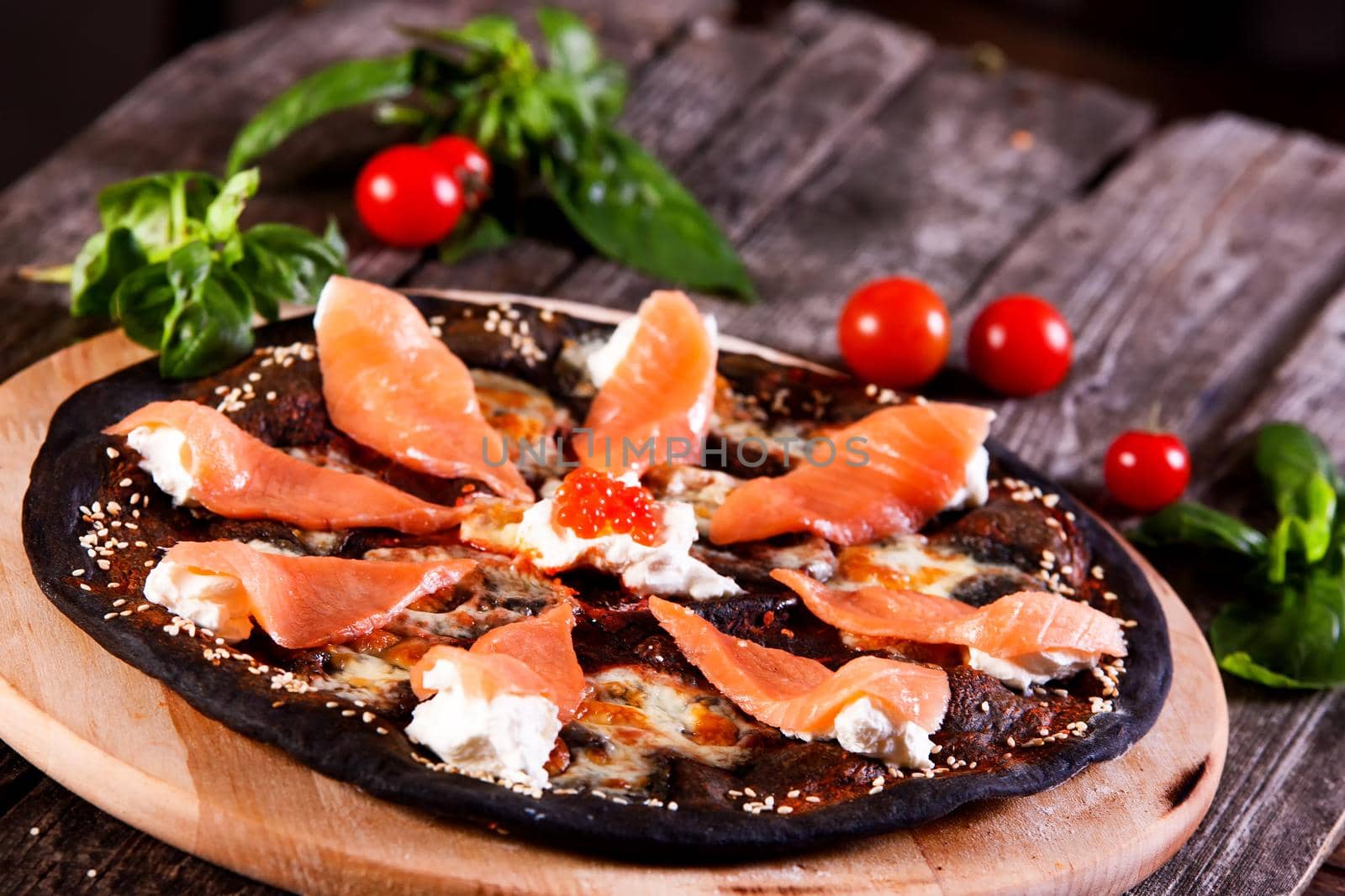 Black pizza with red fish salmon and cream cheese by Jyliana